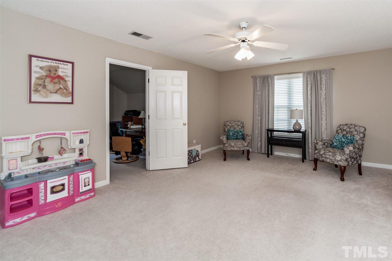 9300 Shallcross Way Raleigh, NC 27617 - Photo 21 of 25 a living room with furniture and a chandelier
