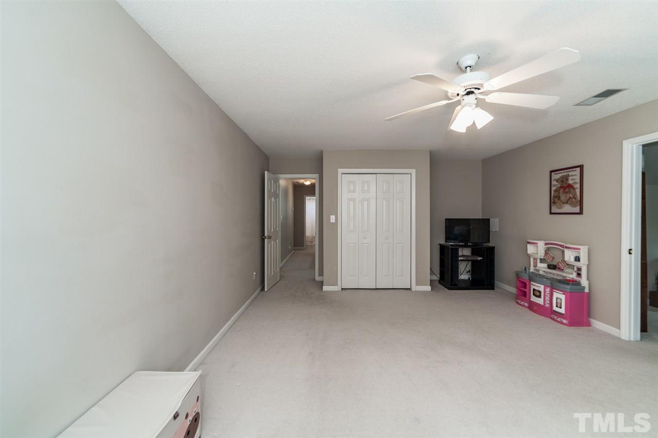 9300 Shallcross Way Raleigh, NC 27617 - Photo 23 of 25 a view of a livingroom with a ceiling fan and window