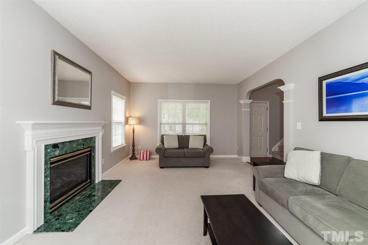 9300 Shallcross Way Raleigh, NC 27617 - Photo 5 of 25 a living room with furniture and a fireplace