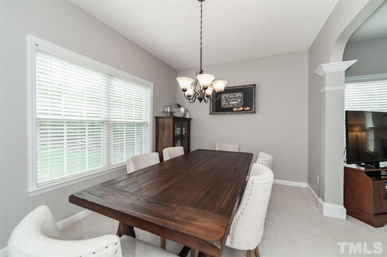 9300 Shallcross Way Raleigh, NC 27617 - Photo 6 of 25 a view of a dining room with furniture window and outside view