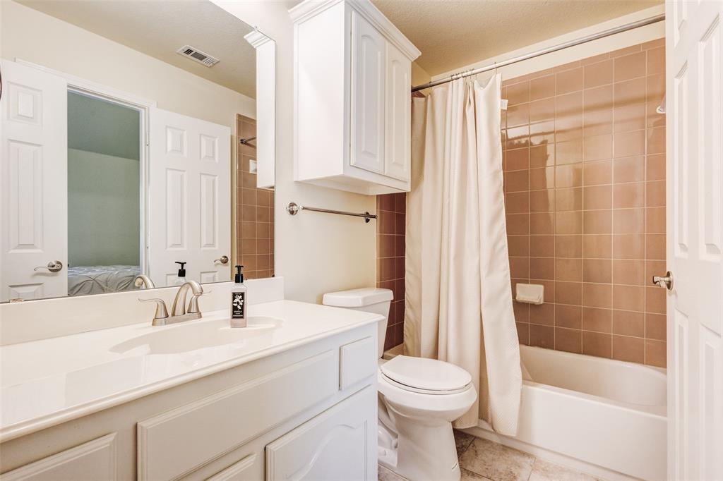 10414 Broadmoor Lane Rowlett, TX 75089 - Photo 29 of 38 Ensuite bathroom with vanity and shower / bathtub combination with curtain