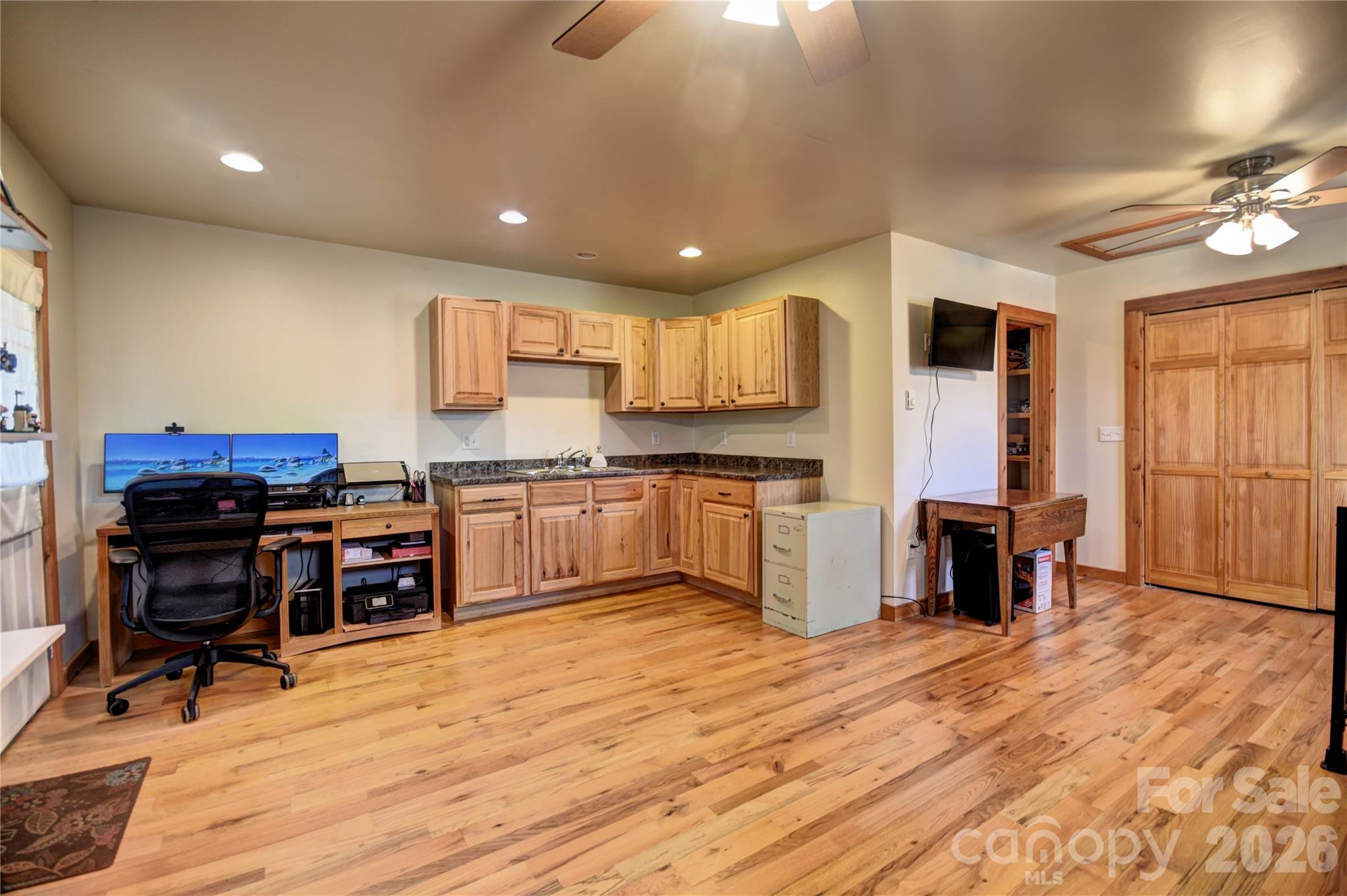 85 Homish Garden Waynesville, NC 28785 - Photo 27 of 32 a kitchen with kitchen island granite countertop wooden floors and a view of living room