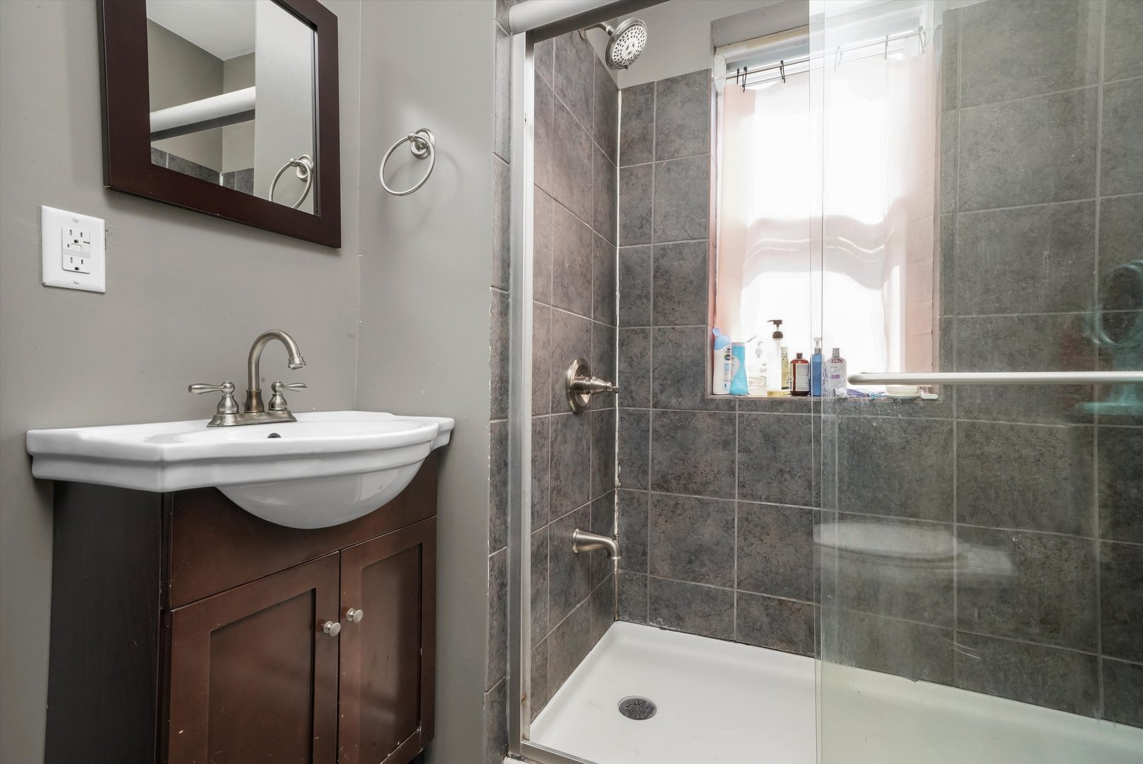 3009 West 40th Place Chicago, IL 60632 - Photo 11 of 33 a bathroom with a sink a mirror and a shower
