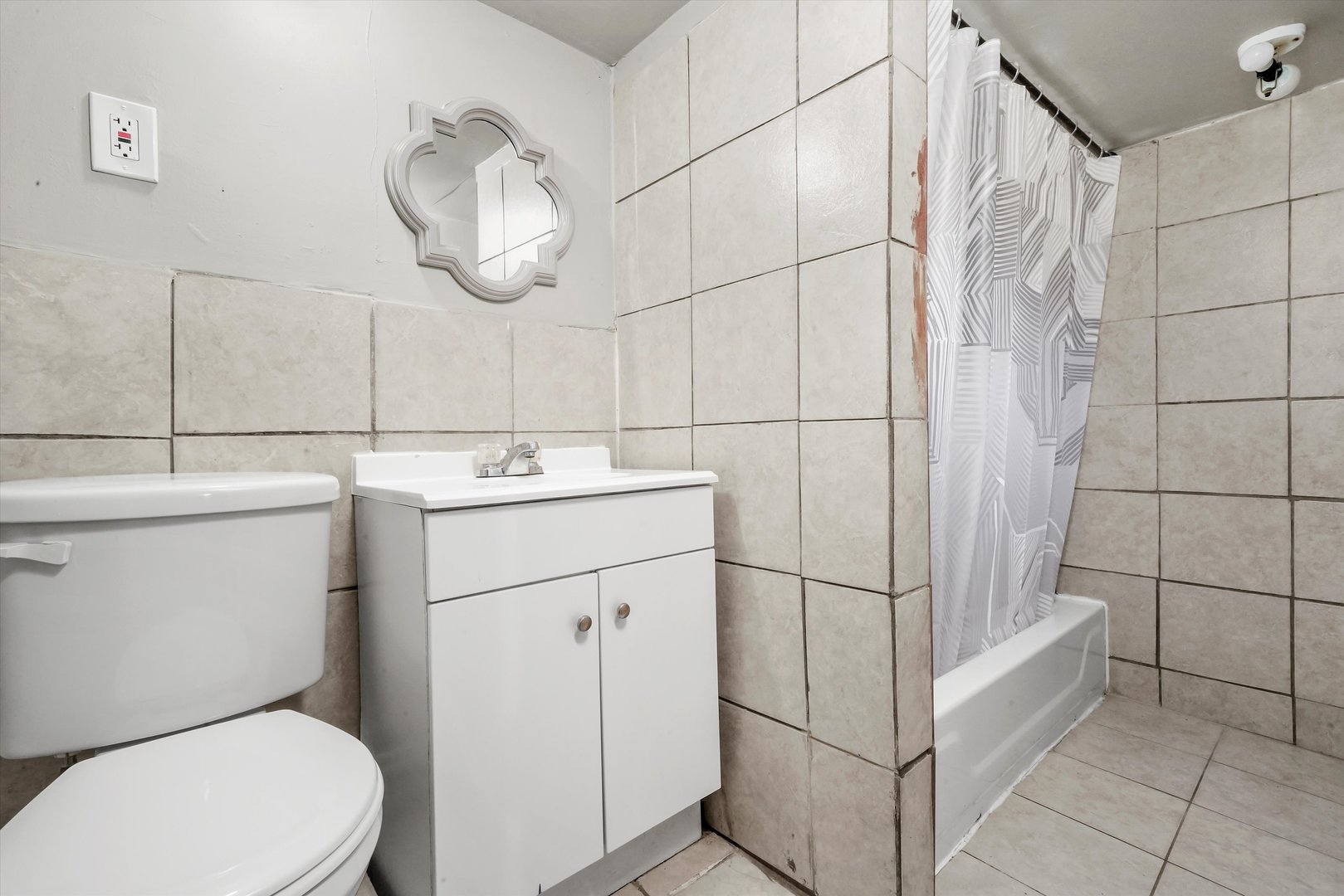 3009 West 40th Place Chicago, IL 60632 - Photo 19 of 33 a bathroom with a toilet sink and mirror