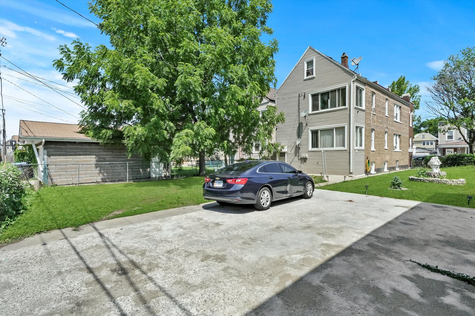 3009 West 40th Place Chicago, IL 60632 - Photo 25 of 33 a car parked in front of a house next to a yard