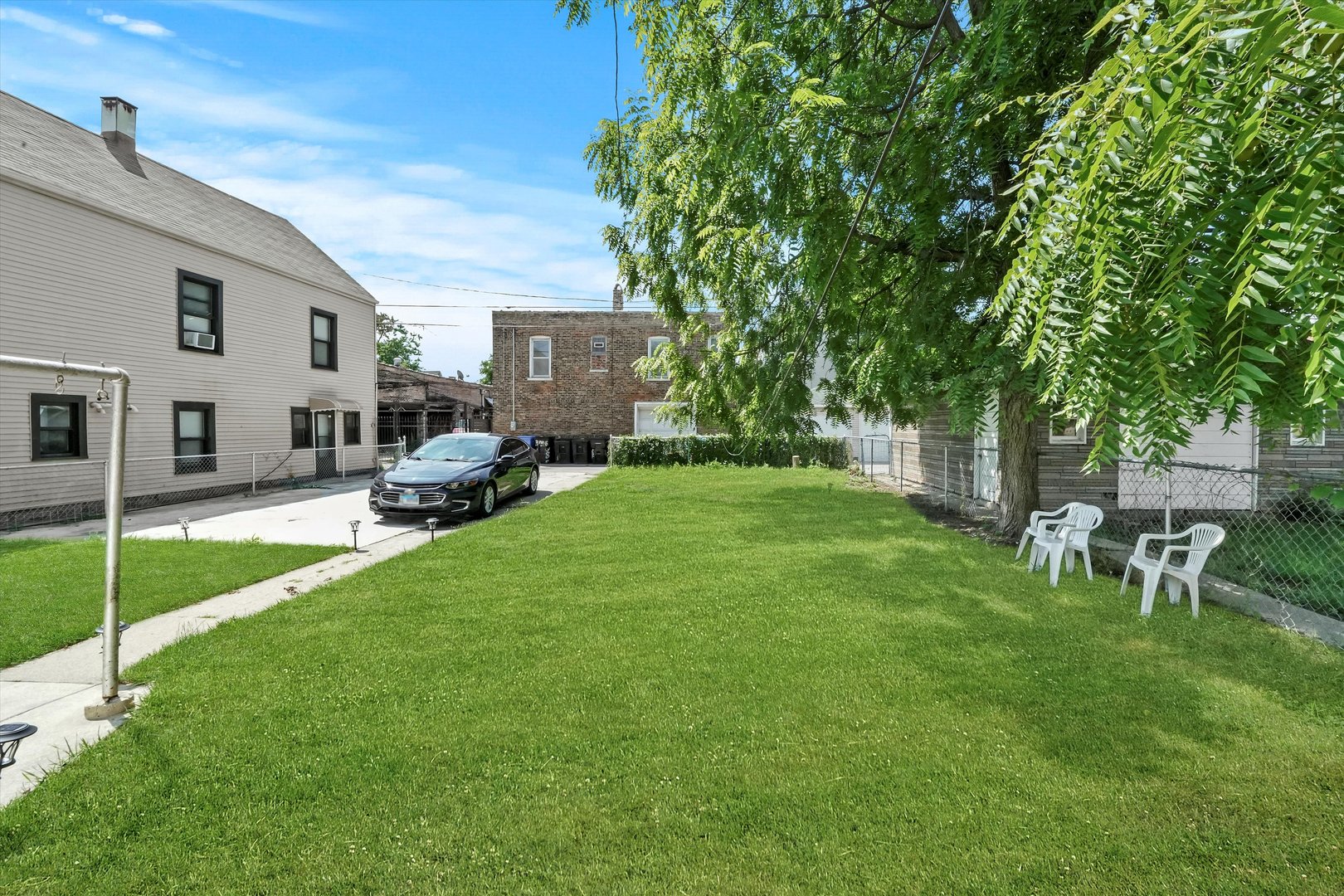 3009 West 40th Place Chicago, IL 60632 - Photo 26 of 33 a view of a house with backyard sitting area and garden