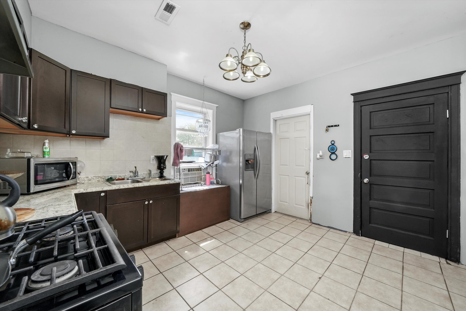 3009 West 40th Place Chicago, IL 60632 - Photo 6 of 33 a kitchen with a stove and a refrigerator