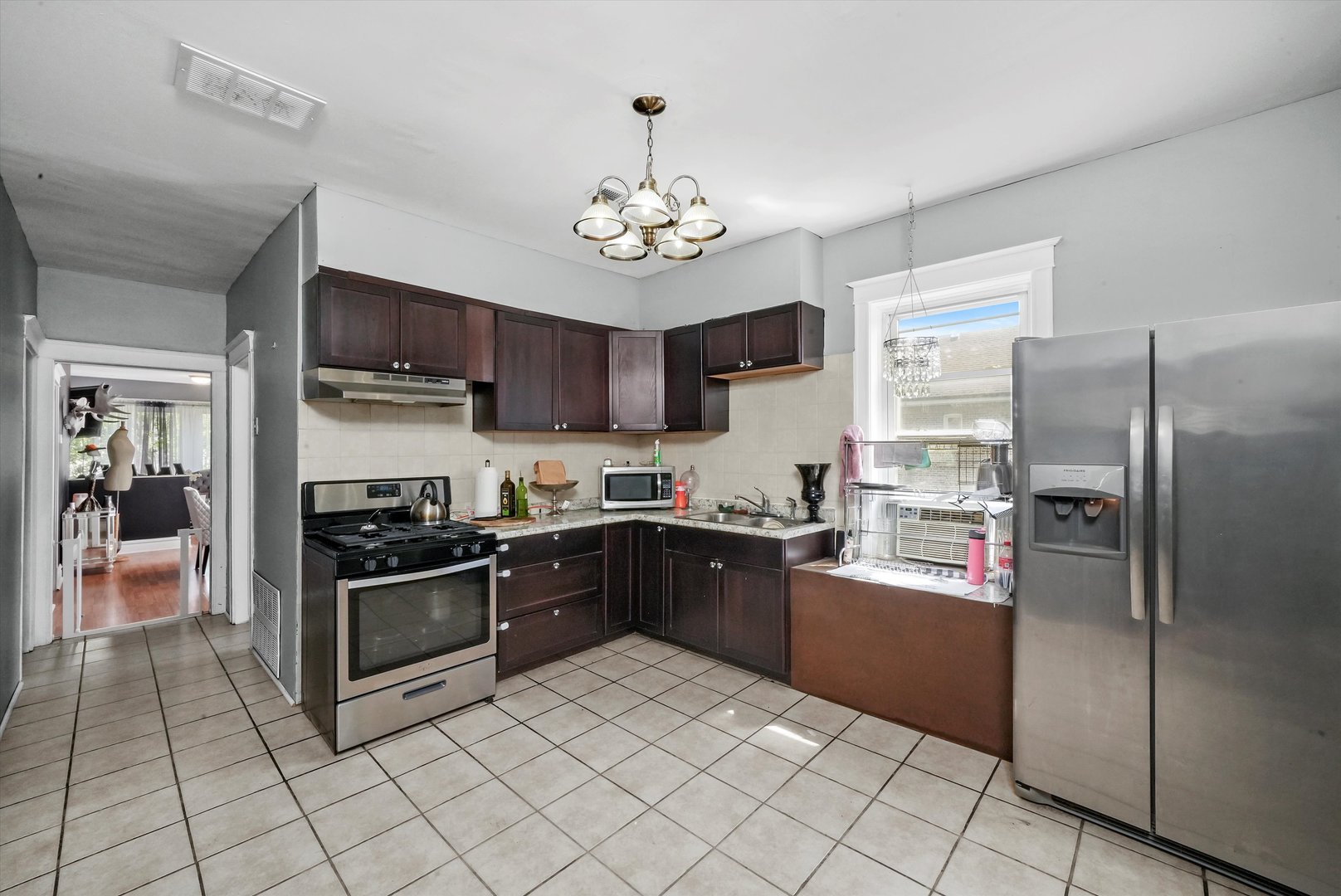 3009 West 40th Place Chicago, IL 60632 - Photo 7 of 33 a kitchen with stainless steel appliances granite countertop a refrigerator oven a sink dishwasher and a refrigerator
