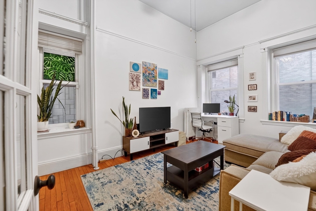 8 Garrison Street, Unit 111 Boston, MA 02116 - Photo 1 of 15 a living room with furniture and a flat screen tv
