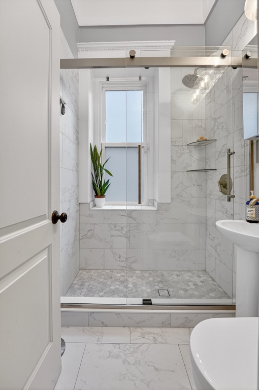 8 Garrison Street, Unit 111 Boston, MA 02116 - Photo 12 of 15 a bathroom with a shower and a bathtub