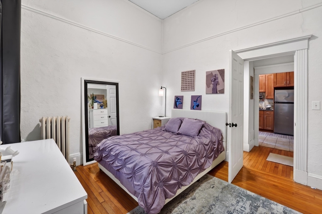 8 Garrison Street, Unit 111 Boston, MA 02116 - Photo 14 of 15 a bedroom with a bed and a table in it