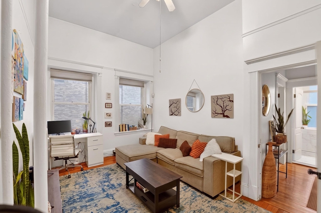 8 Garrison Street, Unit 111 Boston, MA 02116 - Photo 3 of 15 a living room with fireplace furniture and a rug