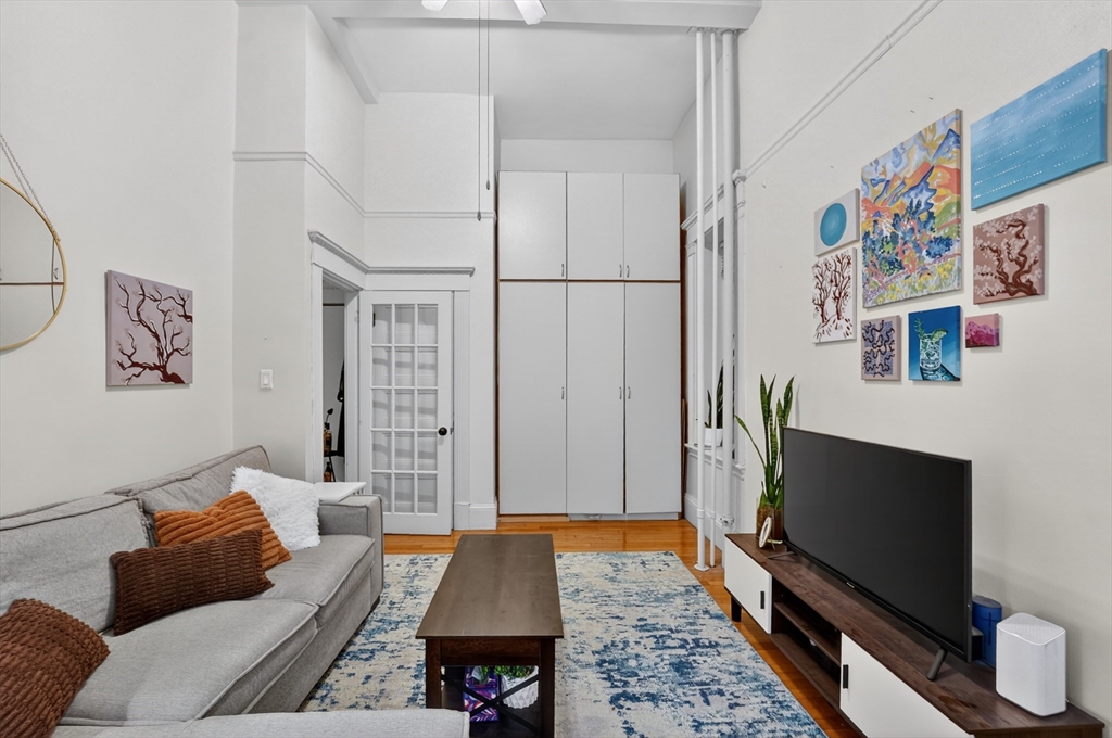 8 Garrison Street, Unit 111 Boston, MA 02116 - Photo 4 of 15 a living room with furniture and a flat screen tv