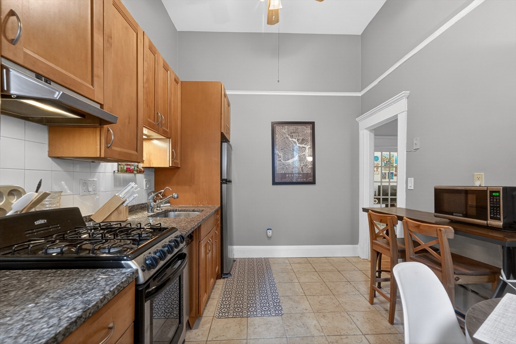 8 Garrison Street, Unit 111 Boston, MA 02116 - Photo 10 of 15 a kitchen with a stove a sink and a refrigerator