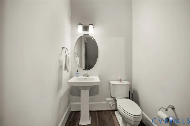 a white toilet sitting next to a bathroom sink