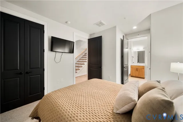 a bedroom with a bed and a television