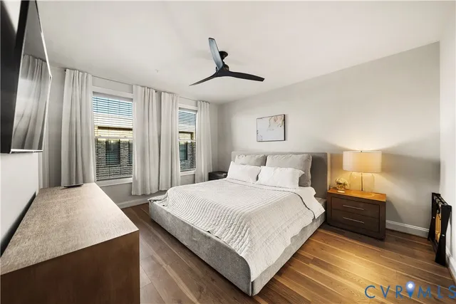 a bedroom with a large bed and a chandelier