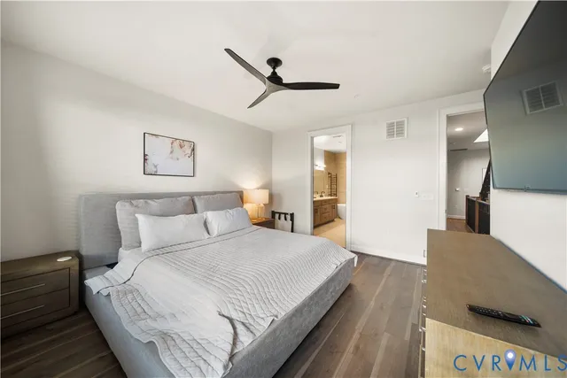 a spacious bedroom with a bed and a large mirror