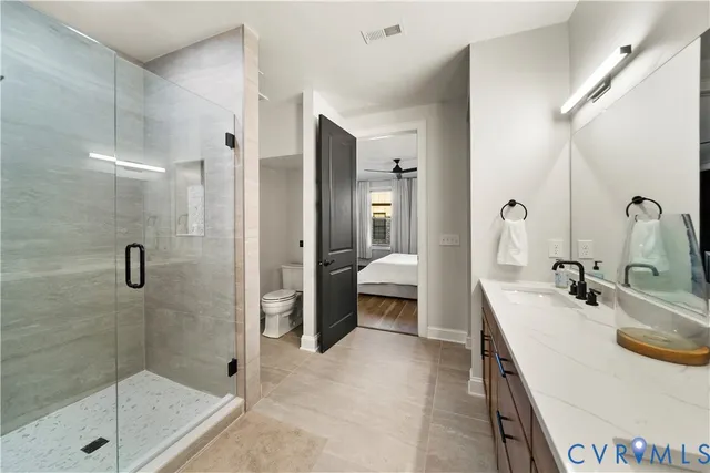 a bathroom with a sink a toilet and a shower