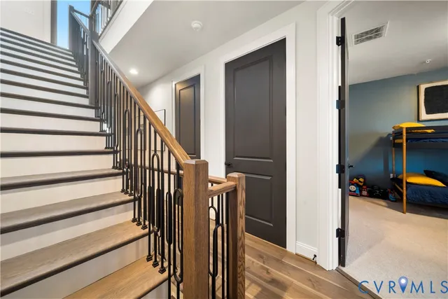 a view of a hallway with entryway wooden floor and windows