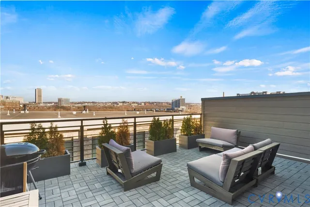 a view of a terrace with couches and lounge chairs