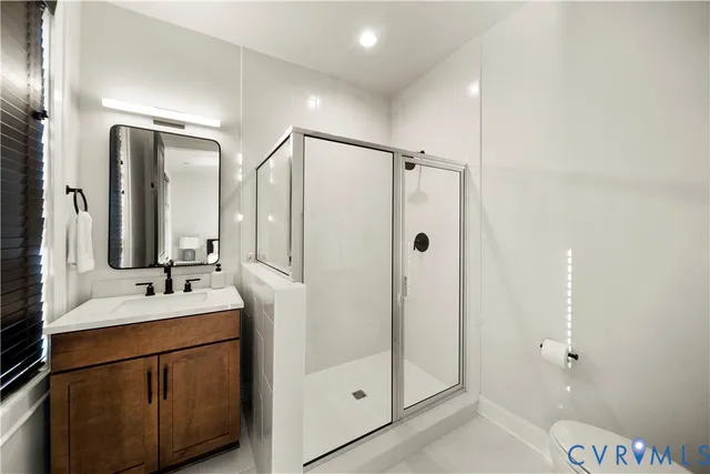 a bathroom with a double vanity sink mirror and shower
