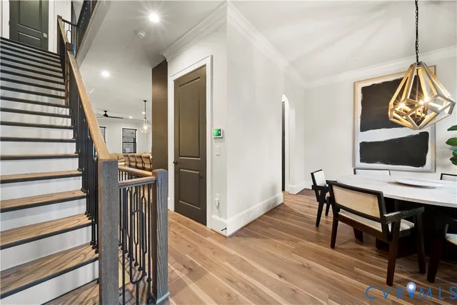 a view of a hallway with furniture and wooden floor