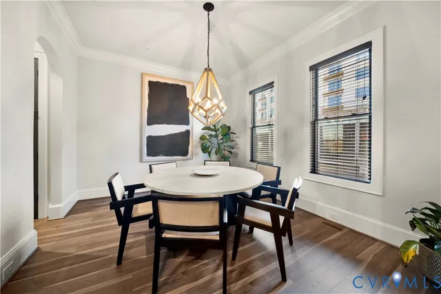 a dining room with furniture window and wooden floor