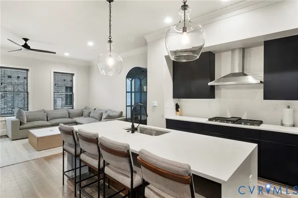 a kitchen with a sink a stove and chairs