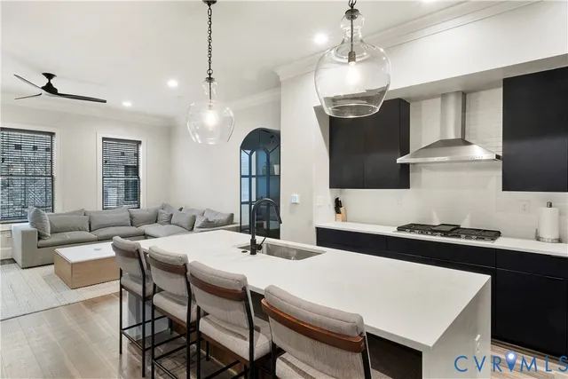 a kitchen with a sink a stove and chairs