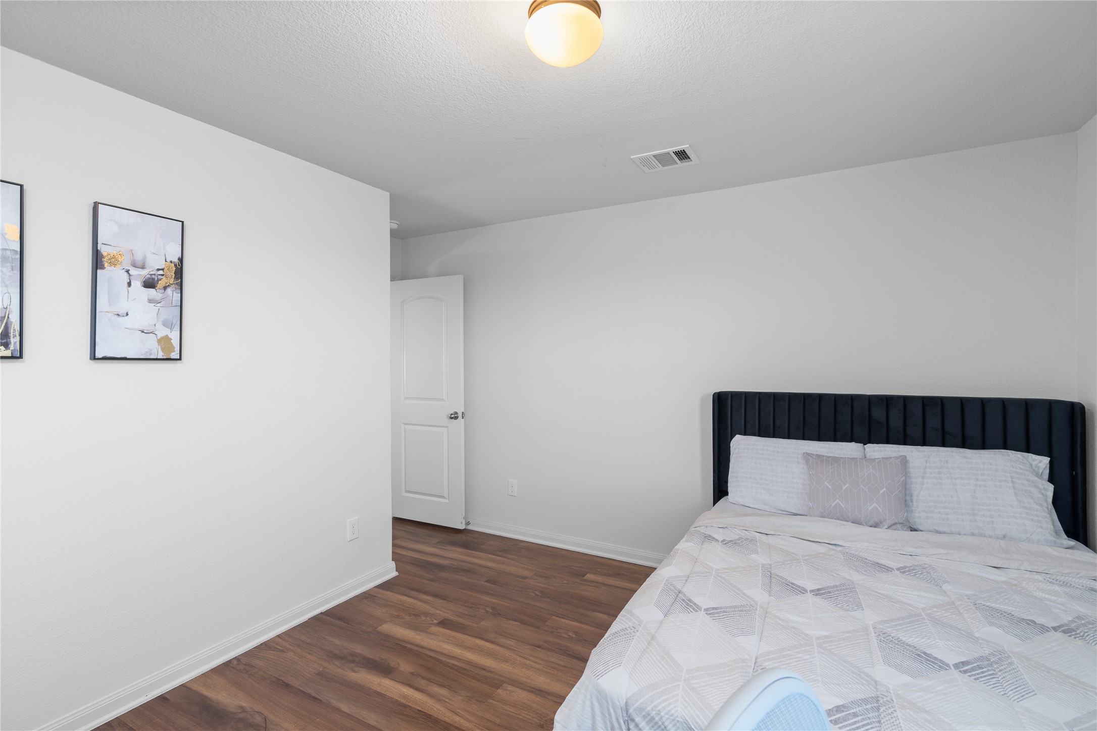 20205 Grover Cleveland Way Manor, TX 78653 - Photo 23 of 26 a bedroom with a bed and a window