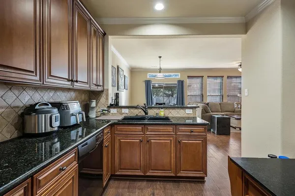 a kitchen with stainless steel appliances granite countertop a sink stove and cabinets
