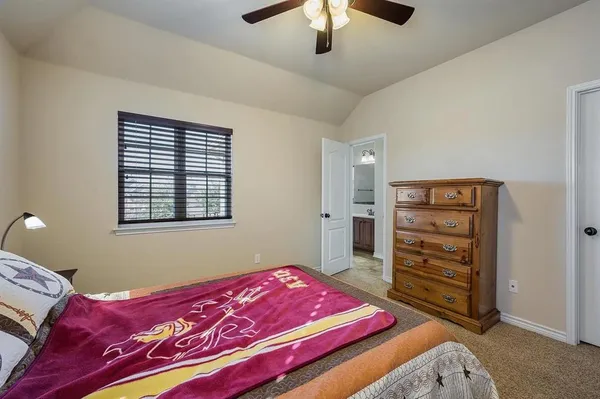 a bedroom with a bed and a dresser