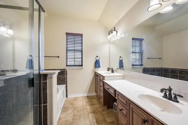a bathroom with a sink double vanity and a mirror