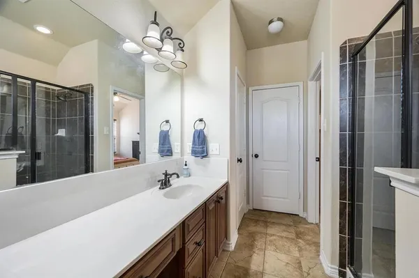 a spacious bathroom with a double vanity sink mirror and shower