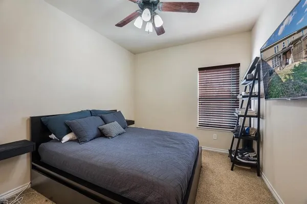 a bedroom with a bed and a chandelier