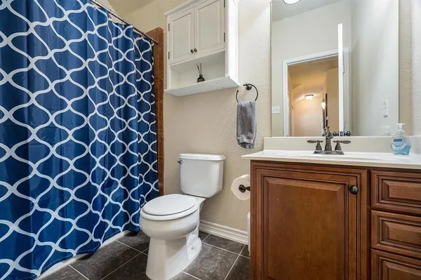 a bathroom with a sink toilet and a mirror
