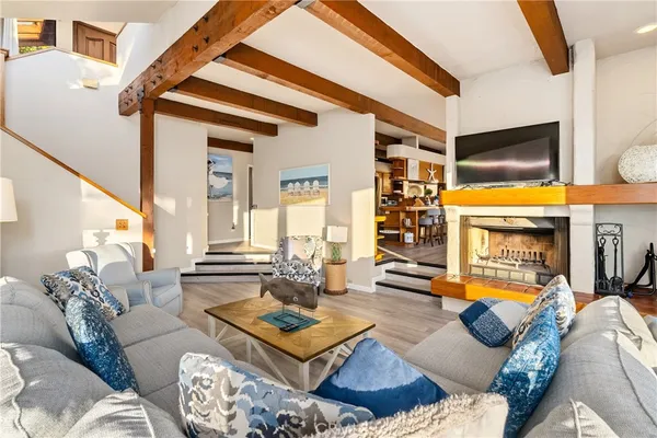 a living room with furniture a rug and a window