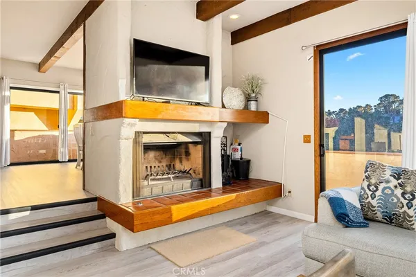 a living room with furniture pool table and a fireplace