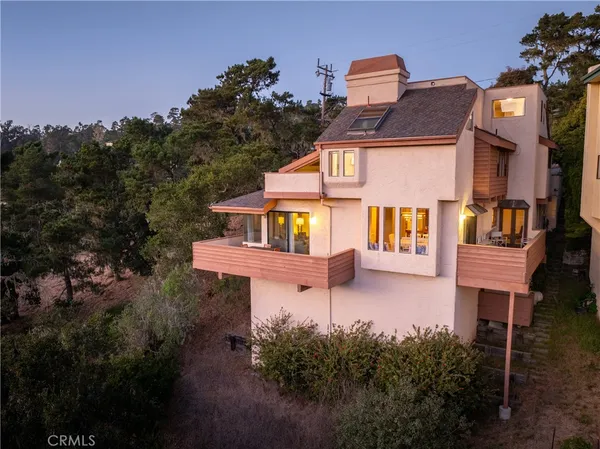 a aerial view of a house with balcony and trees al around