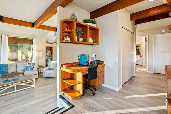 a living room with patio furniture and a table