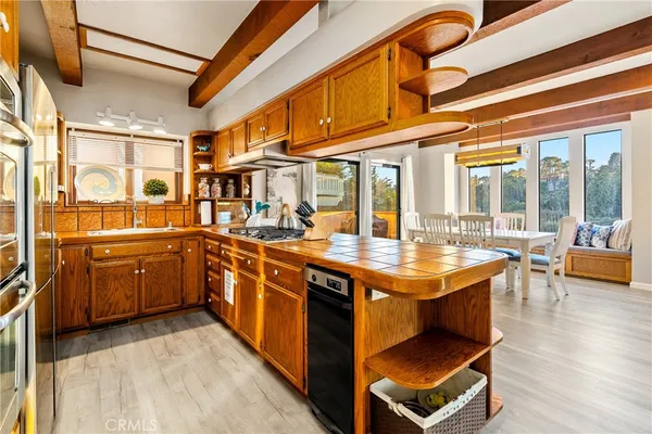 a kitchen with stainless steel appliances granite countertop a stove and cabinets