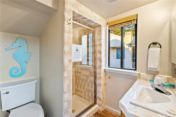 a bathroom with a sink toilet and shower