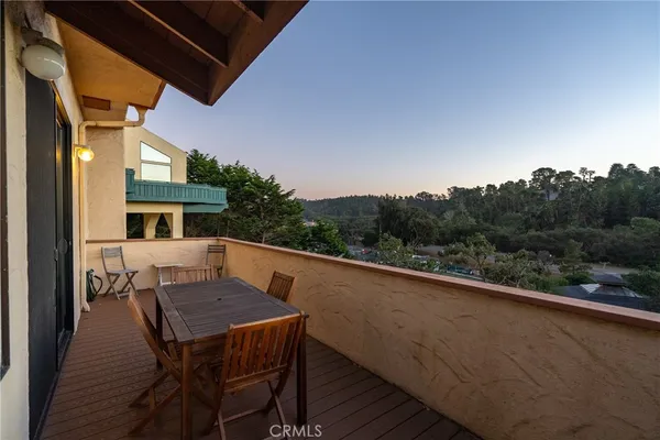 a balcony view with a seating space