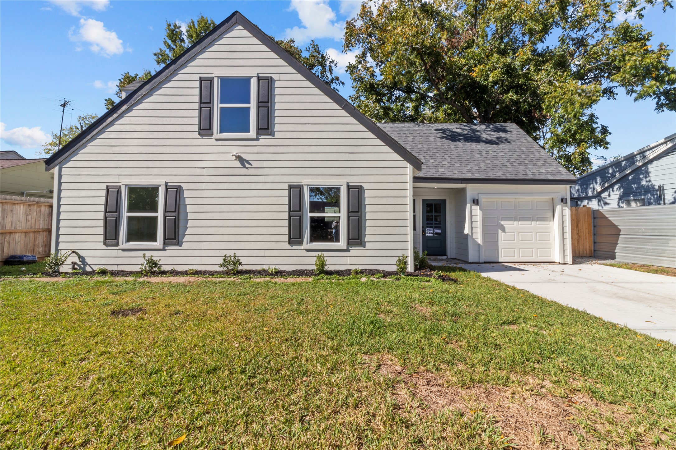 a backyard of a house with table and chairs