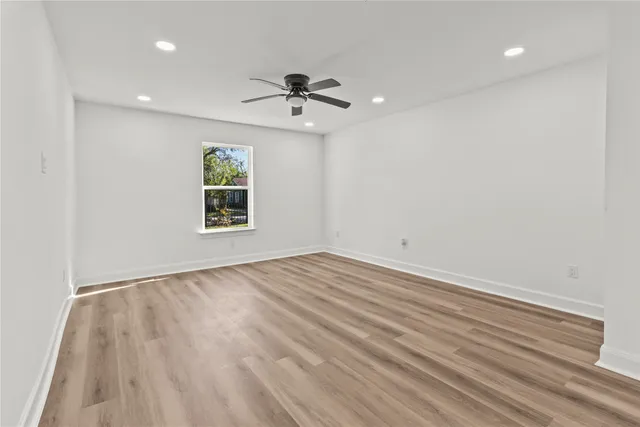 wooden floor in an empty room with a window