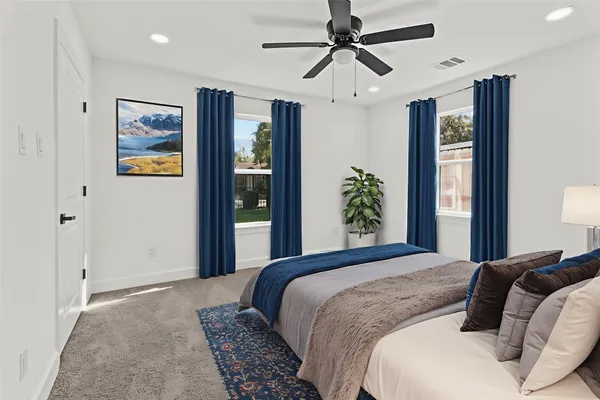 a bedroom with a large bed and a chandelier