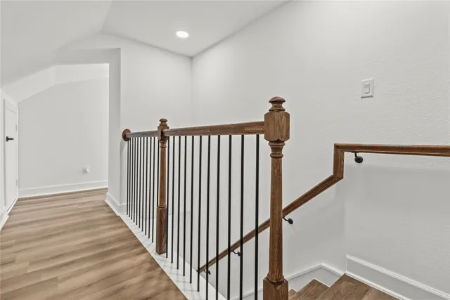 a view of a hallway with wooden floor
