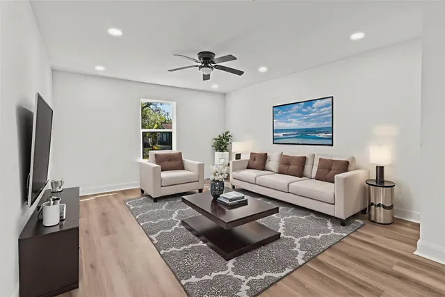 a living room with furniture a table and a flat screen tv