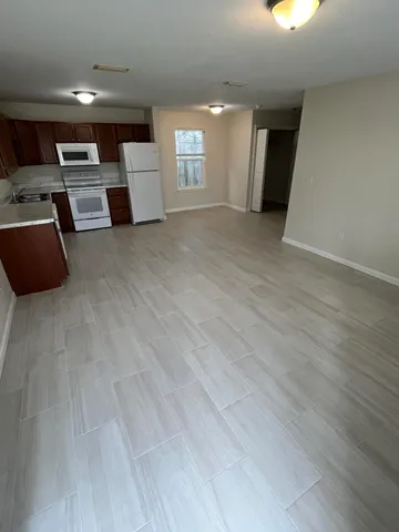 a view of a kitchen with a sink and a refrigerator